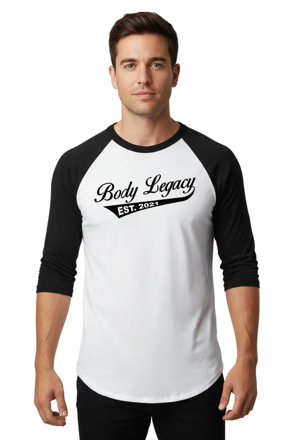 A 3/4 sleeve raglan baseball t-shirt with a white body and black sleeves, featuring a black graphic on the chest that reads 'Body Legacy EST. 2021'.