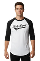 A 3/4 sleeve raglan baseball t-shirt with a white body and black sleeves, featuring a black graphic on the chest that reads 'Body Legacy EST. 2021'.